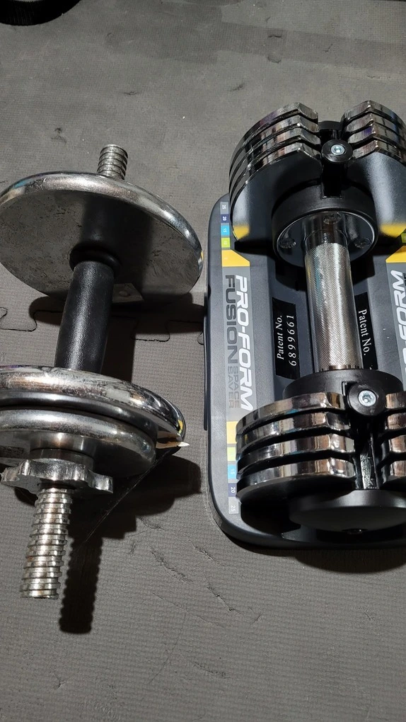 The Proform adjustable dumbbell on the right, a typical spin lock adjustable one on the left